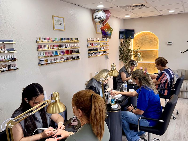Nail technicians working with clients inside Aloha Beauty Salon
